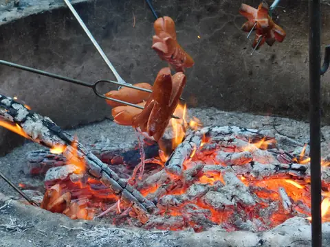 Opékání špekáčků nad ohništěm